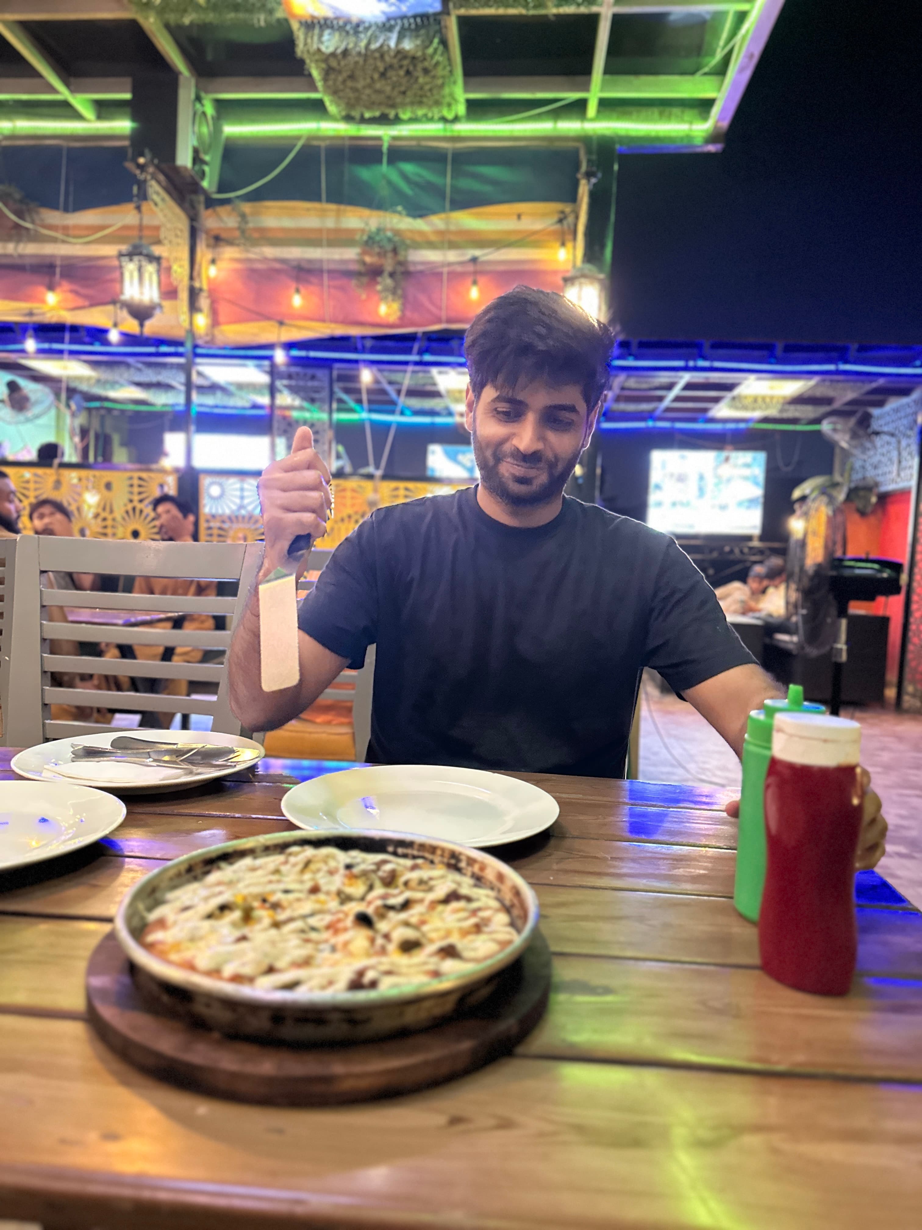 Shahzada Ali Hassan with pizza